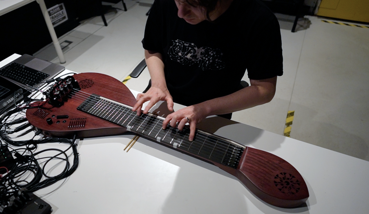 Federico Visi playing the Sophtar – a table-top feedback string instrument – in Studio 6 at IRCAM.